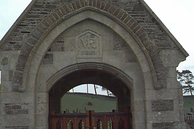 Archway to the cemetery and Crest "VR 1869"